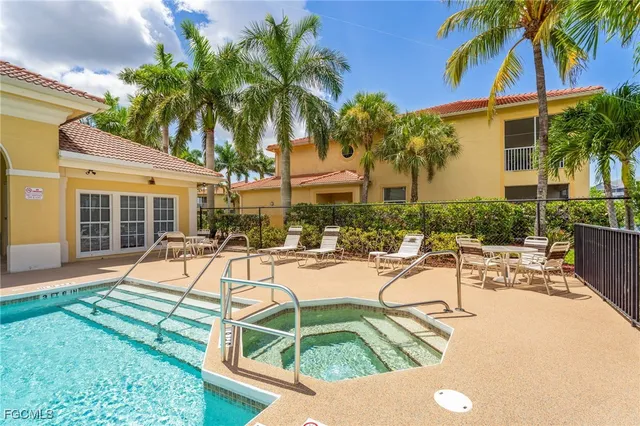 a view of a house with swimming pool and sitting area