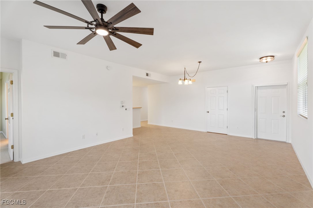 4336 Bellasol Circle, Unit 2911 Fort Myers, FL 33916 - Photo 9 of 45 en empty room with ceiling fan and window