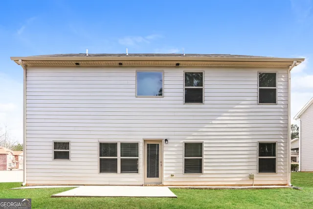 a view of a house with a yard and a large window