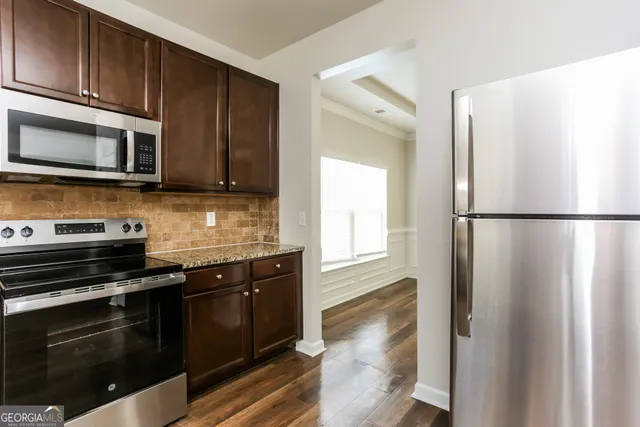 a kitchen with stainless steel appliances and wooden cabinets