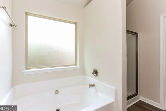 a white bath tub sitting next to a window