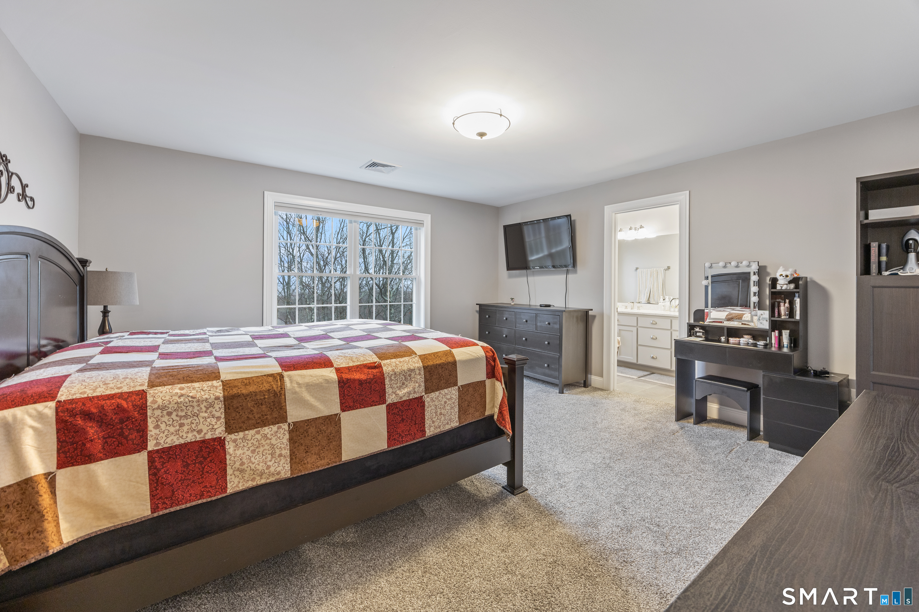 52 Brookview Circle, Unit 52 Bristol, CT 06010 - Photo 19 of 29 a spacious bedroom with a bed a table and chair