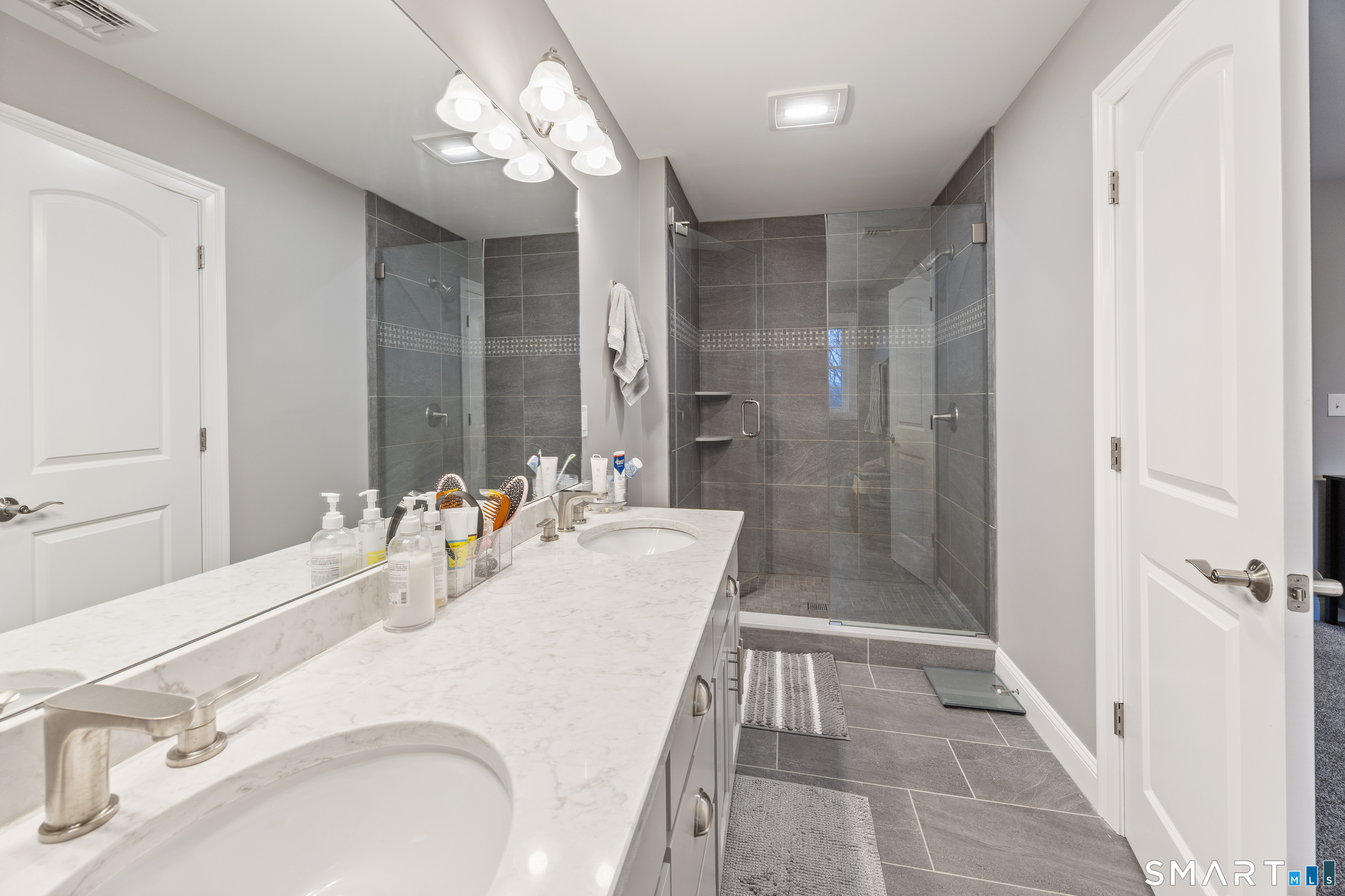 52 Brookview Circle, Unit 52 Bristol, CT 06010 - Photo 20 of 29 a bathroom with a sink shower and a mirror