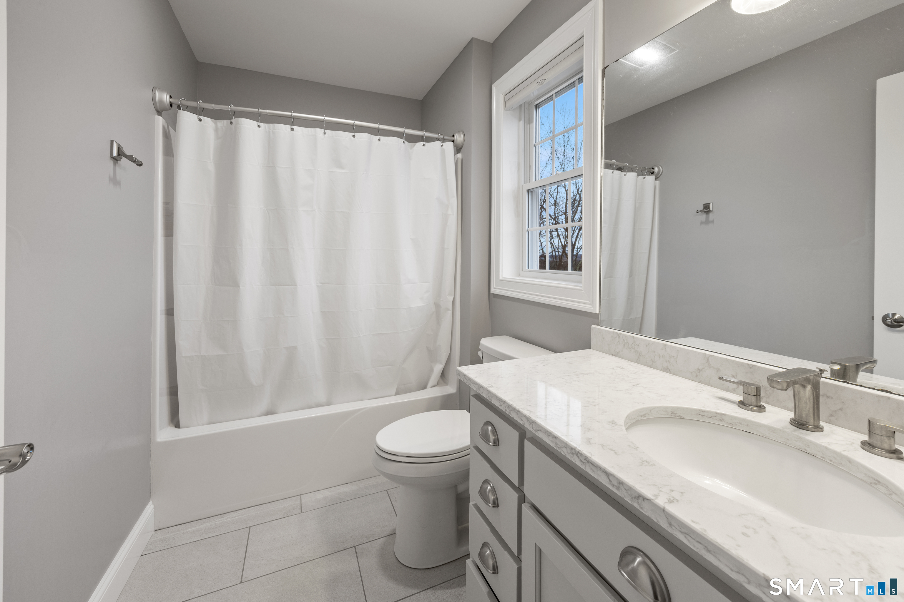 52 Brookview Circle, Unit 52 Bristol, CT 06010 - Photo 23 of 29 a bathroom with a sink a toilet and shower curtain