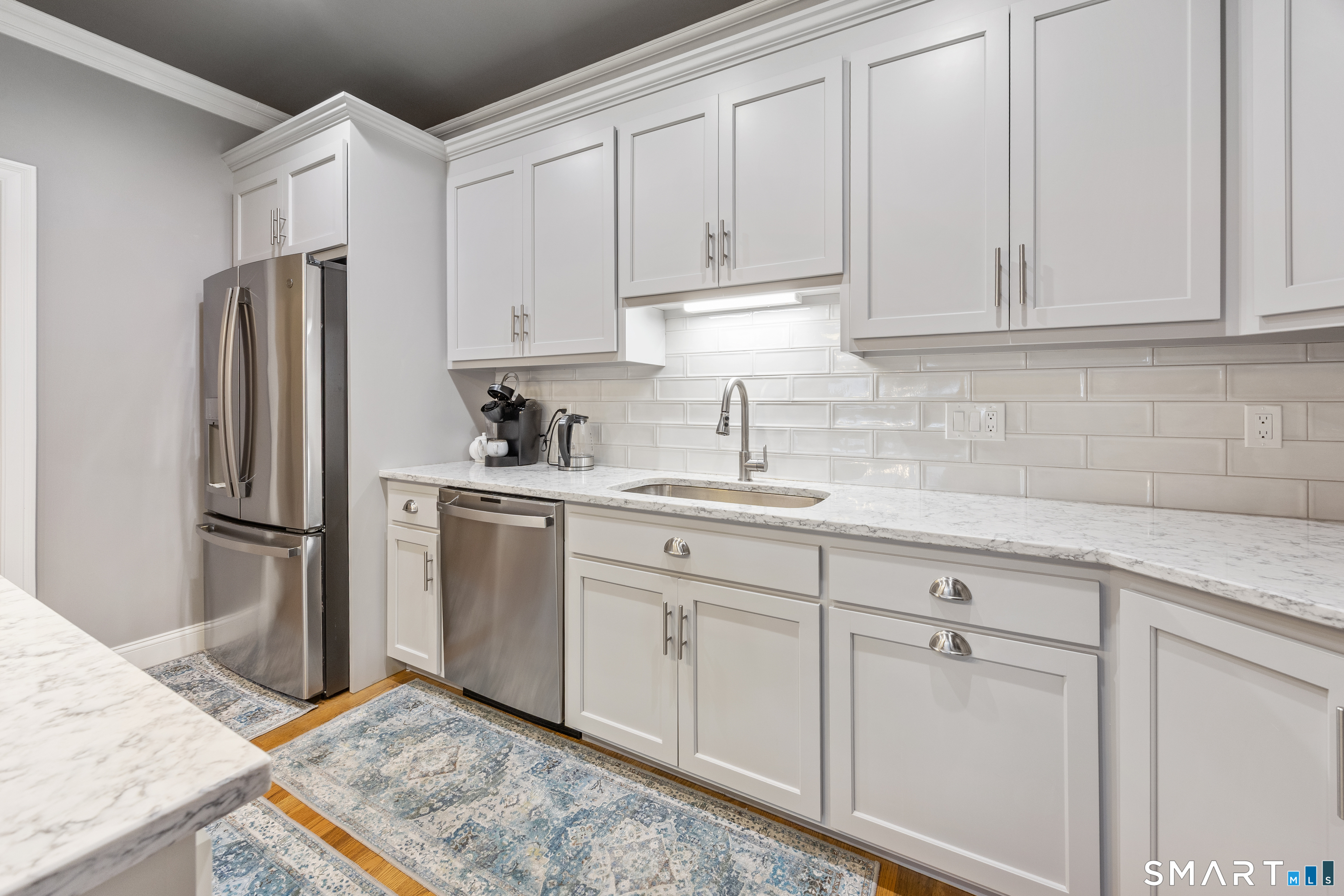 52 Brookview Circle, Unit 52 Bristol, CT 06010 - Photo 5 of 29 a kitchen with white cabinets and refrigerator
