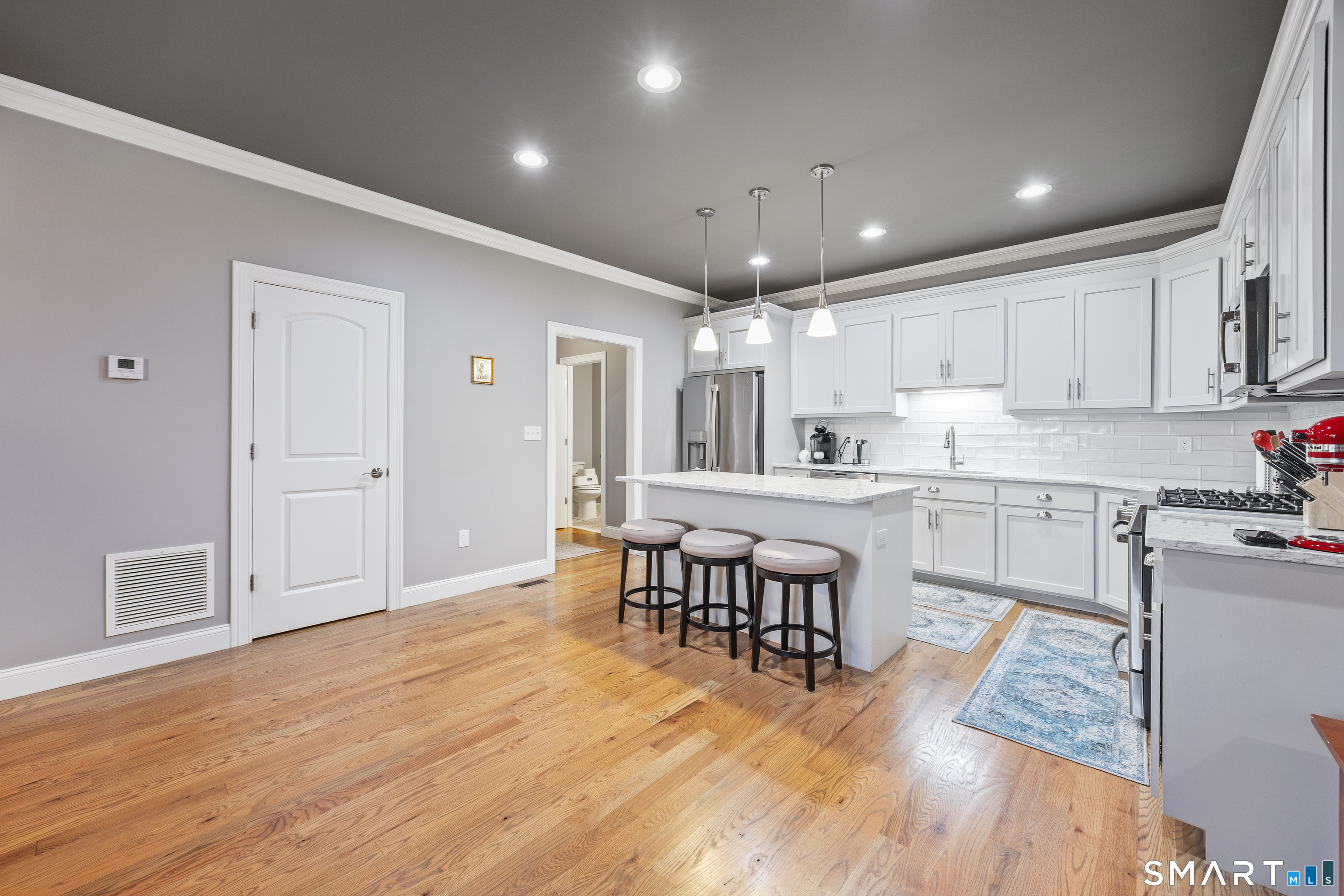 52 Brookview Circle, Unit 52 Bristol, CT 06010 - Photo 6 of 29 a kitchen with stainless steel appliances granite countertop a refrigerator a sink dishwasher a stove and white cabinets with wooden floor