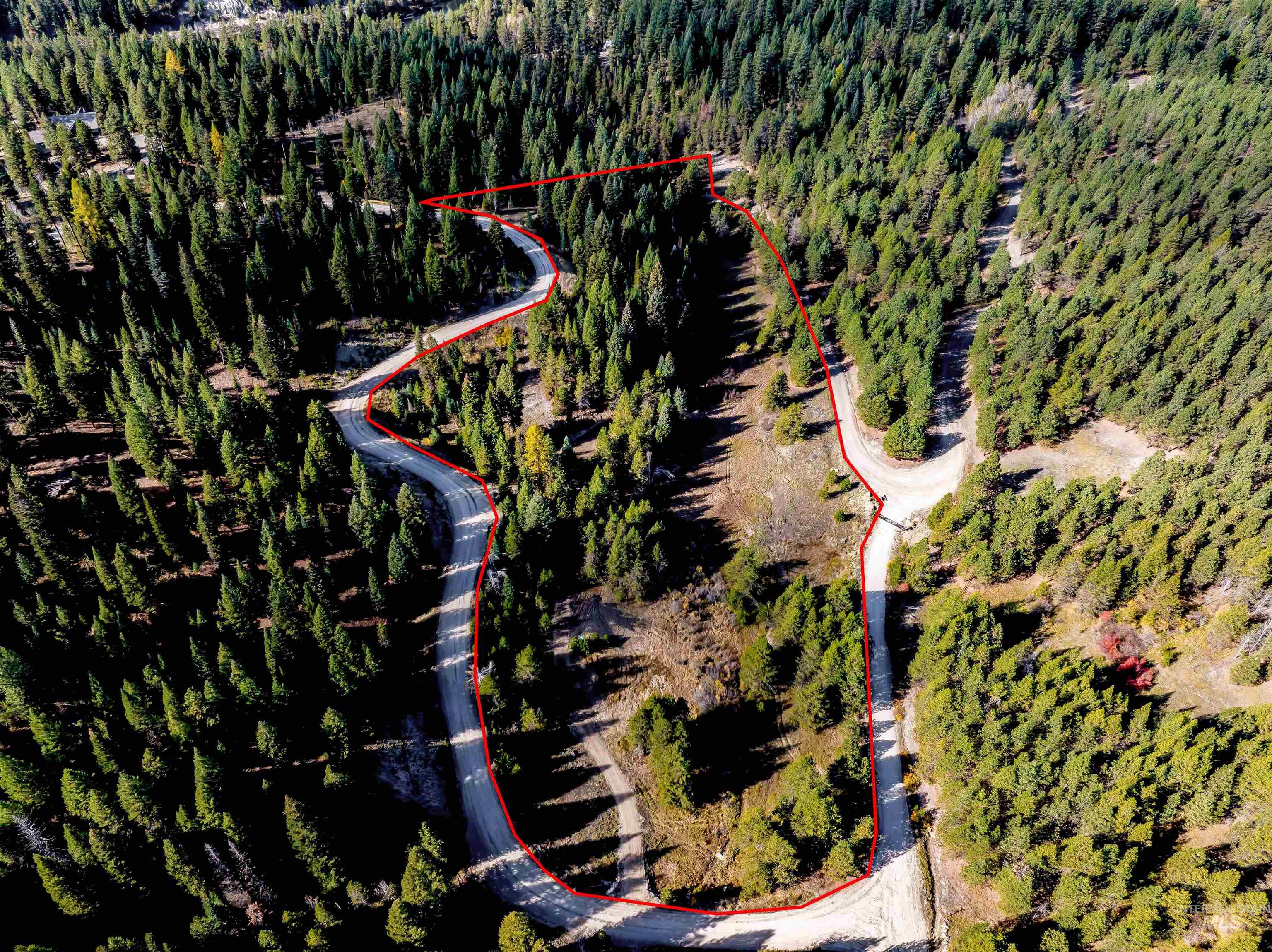 201 Tripod View Cascade, ID 83611 - Photo 10 of 41 Aerial view of property and surrounding area featuring property parcel outlined and a heavily wooded area
