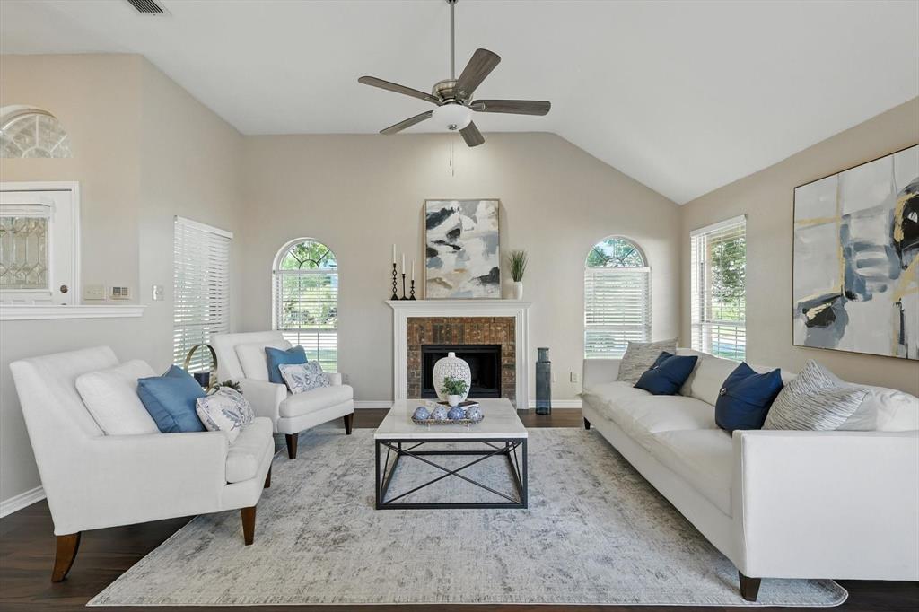 2909 Micarta Drive Plano, TX 75025 - Photo 1 of 1 a living room with furniture a rug and a fireplace