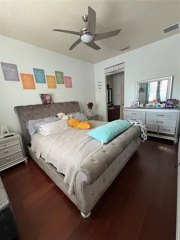 a bedroom with a bed couch and a window