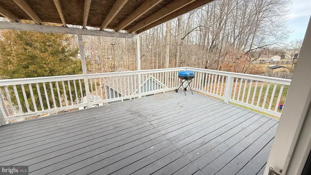 a view of backyard with a deck and wooden floor