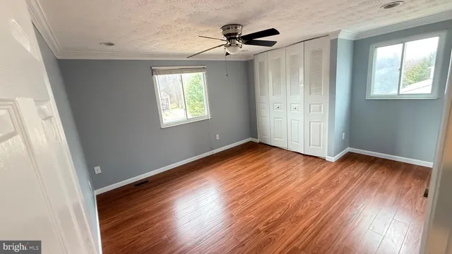 a kitchen with stainless steel appliances a sink a stove a chimney a refrigerator and cabinets