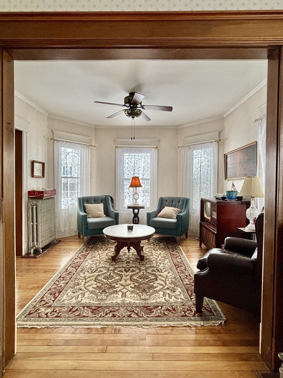 142 Sanders Avenue Lowell, MA 01851 - Photo 11 of 28 a living room with furniture a rug and a chandelier