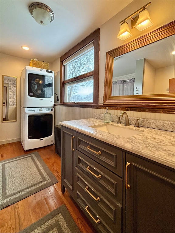 142 Sanders Avenue Lowell, MA 01851 - Photo 21 of 28 a bathroom with a sink a large mirror and a window