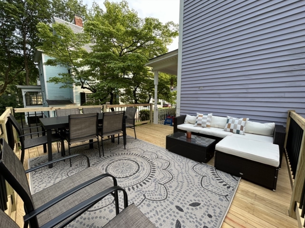 142 Sanders Avenue Lowell, MA 01851 - Photo 25 of 28 a view of a patio with couches and a potted plant