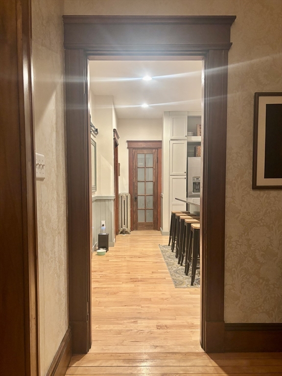 142 Sanders Avenue Lowell, MA 01851 - Photo 3 of 28 a view of a room with a door and wooden floor