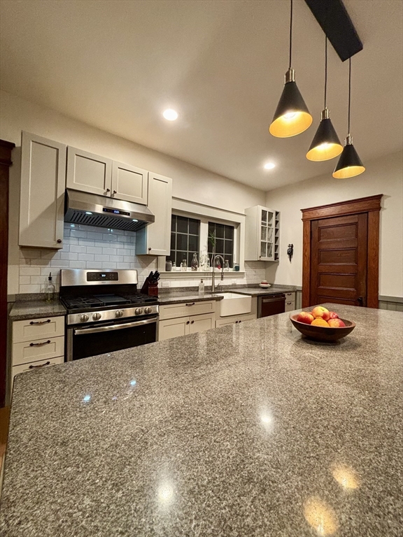 142 Sanders Avenue Lowell, MA 01851 - Photo 7 of 28 a kitchen with stainless steel appliances and a stove top oven