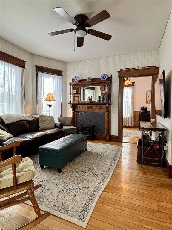 142 Sanders Avenue Lowell, MA 01851 - Photo 9 of 28 a living room with furniture and a fireplace