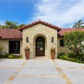 a view of a house with potted plants and a porch