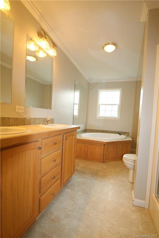 263 Unity Church Road Kings Mountain, NC 28086 - Photo 14 of 22 a bathroom with a granite countertop sink toilet a large mirror a bathtub and window
