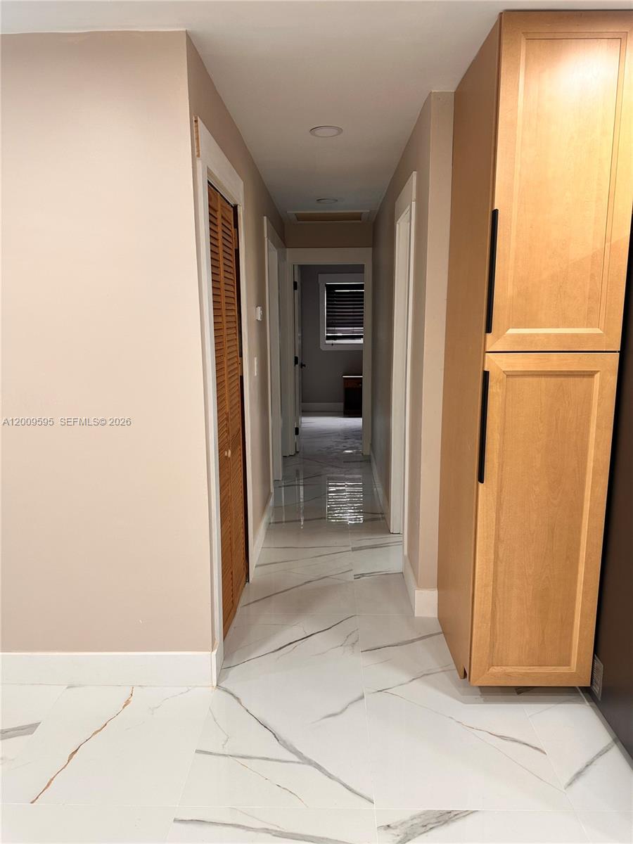 3614 Everglades Road Palm Beach Gardens, FL 33410 - Photo 4 of 9 a view of a hallway with furniture and front door