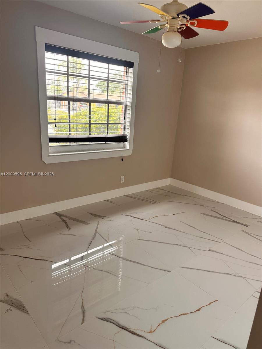 3614 Everglades Road Palm Beach Gardens, FL 33410 - Photo 6 of 9 a bathroom with a window and a fan