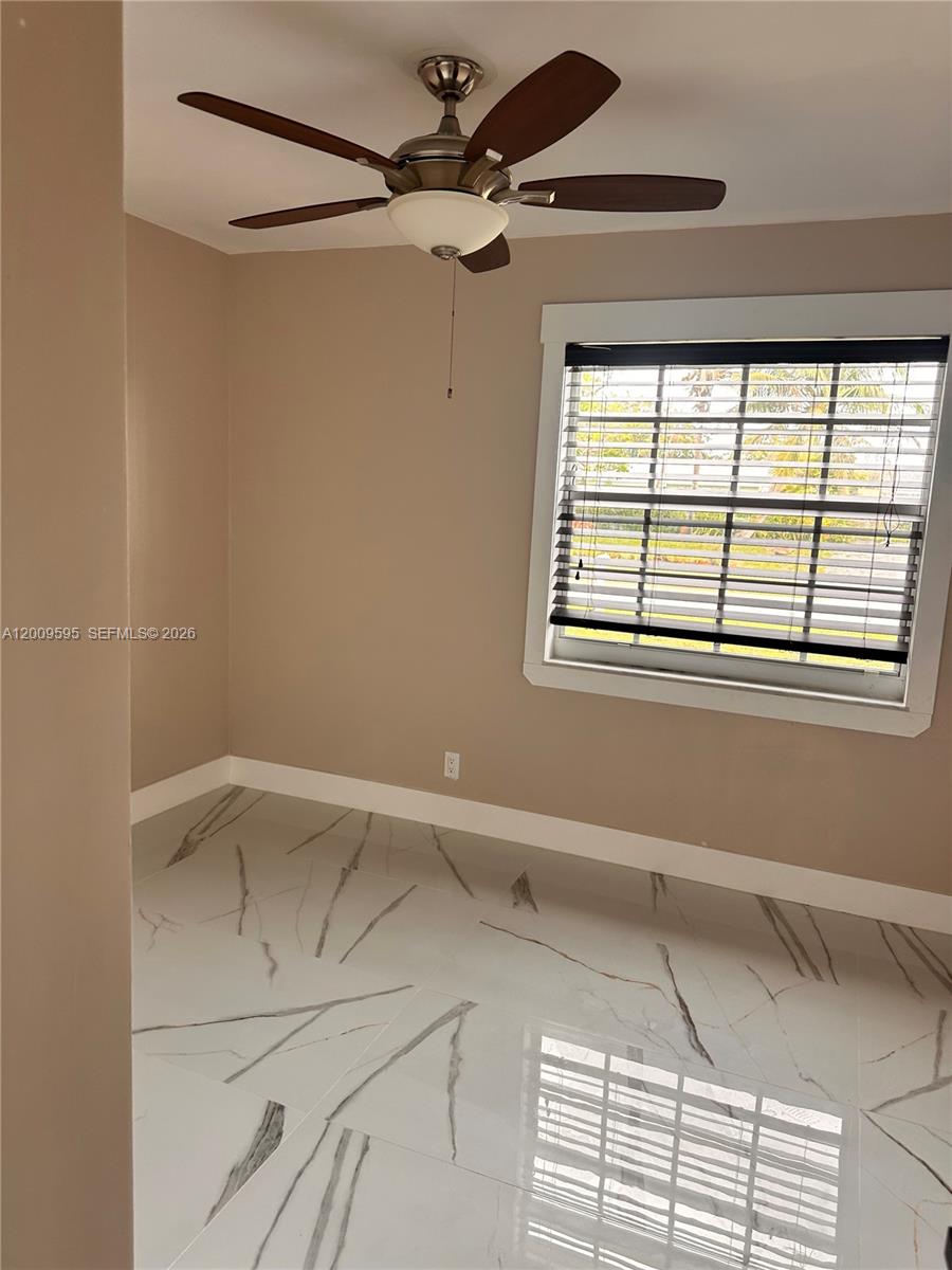 3614 Everglades Road Palm Beach Gardens, FL 33410 - Photo 7 of 9 a view of an empty room with a window