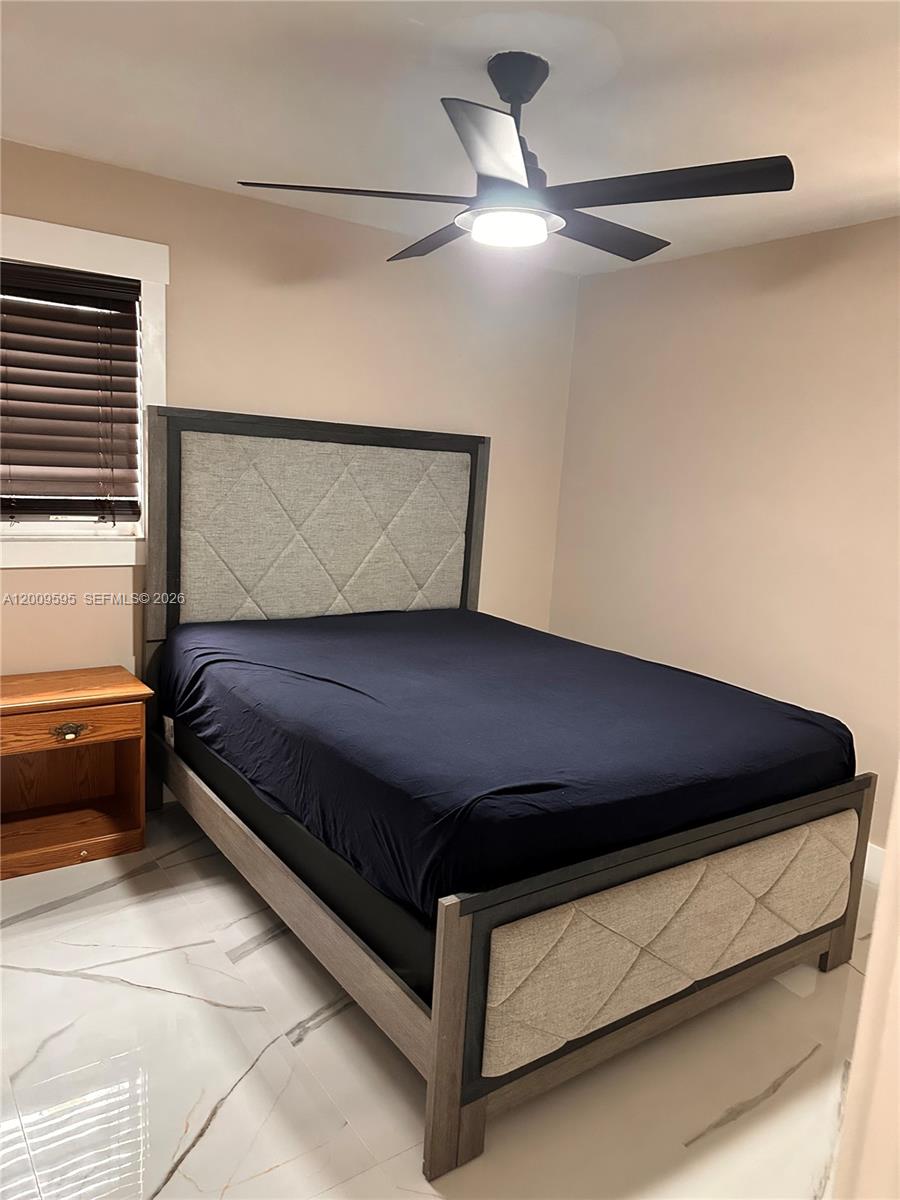 3614 Everglades Road Palm Beach Gardens, FL 33410 - Photo 8 of 9 a bed sitting in a bedroom next to a window