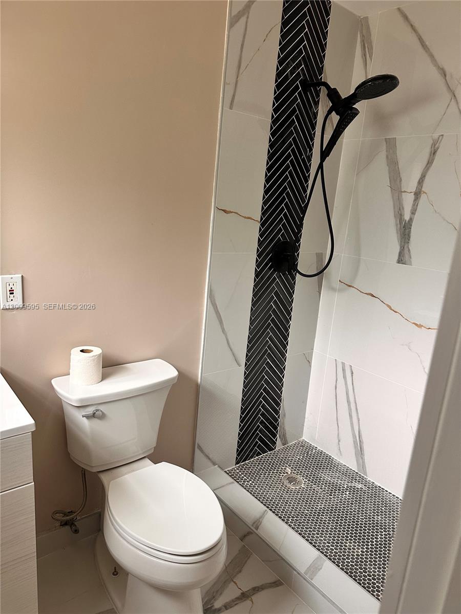 3614 Everglades Road Palm Beach Gardens, FL 33410 - Photo 9 of 9 a white toilet sitting next to a white wall