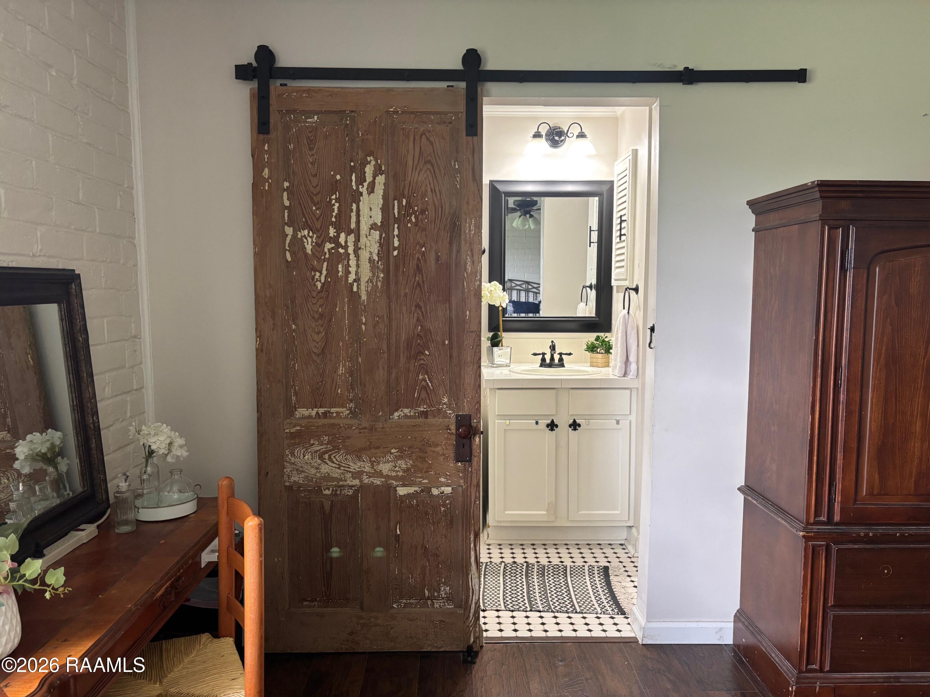 218 Fallis Road Lafayette, LA 70507 - Photo 18 of 28 218 Fallis barn door to bathroom
