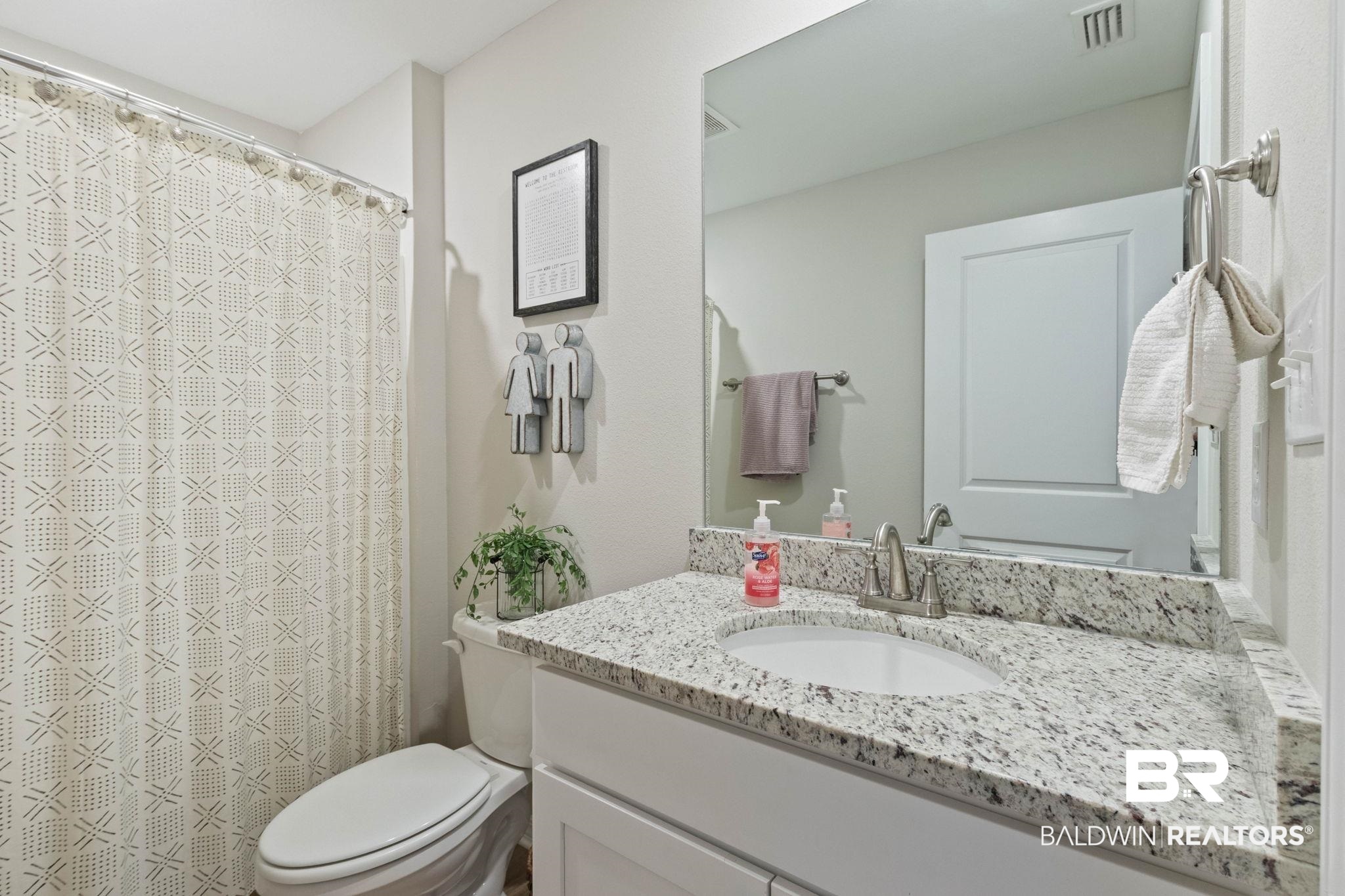 1203 Hayward Loop Foley, AL 36535 - Photo 24 of 41 Bathroom featuring vanity and curtained shower