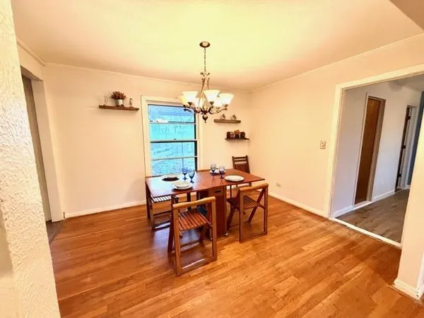 a view of a dining room with furniture and window
