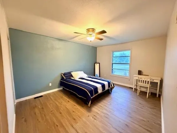 a bedroom with a bed and a chair