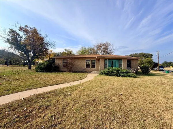 a front view of house with yard and car parked