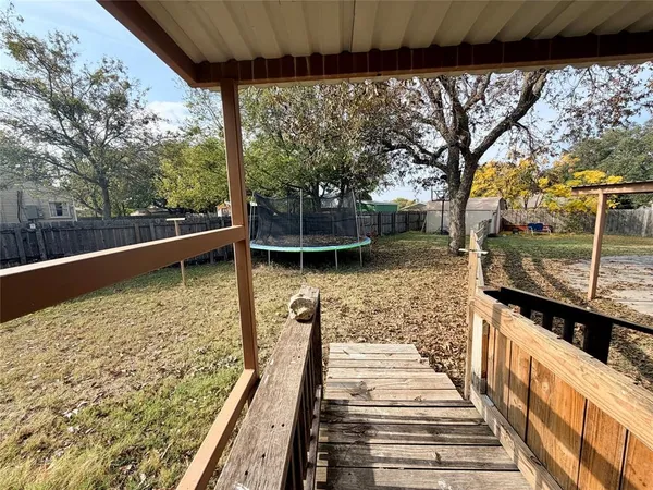a view of balcony with wooden floor