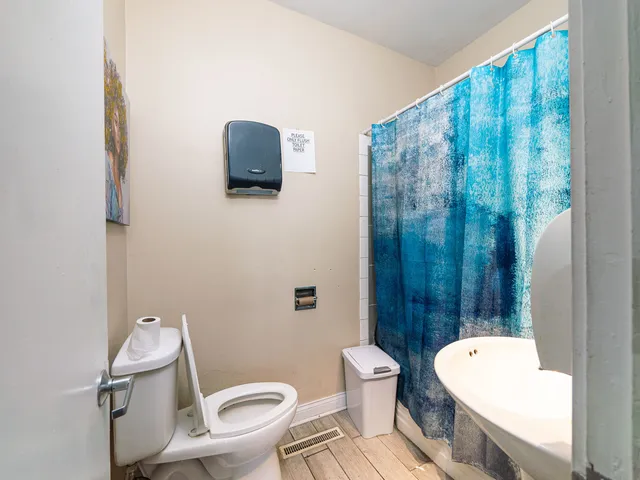 a white toilet sitting next to a bathroom sink and tub