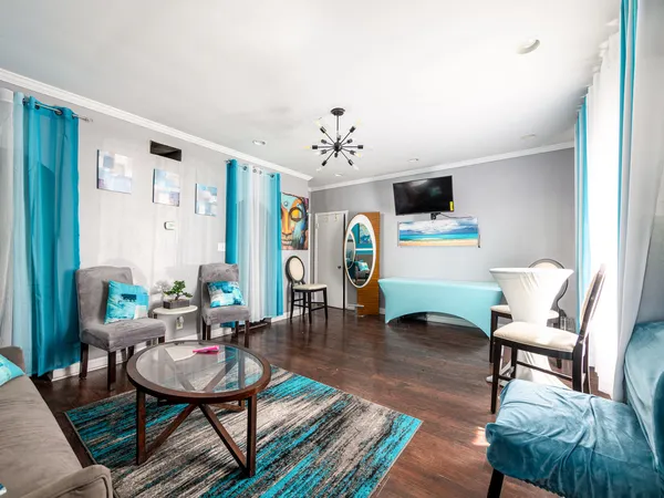 a living room with furniture and a wooden floor