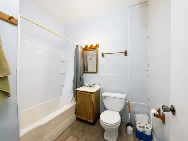 a white toilet sitting next to a bath tub