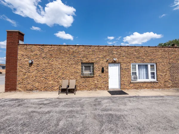 a view of a brick house with a yard