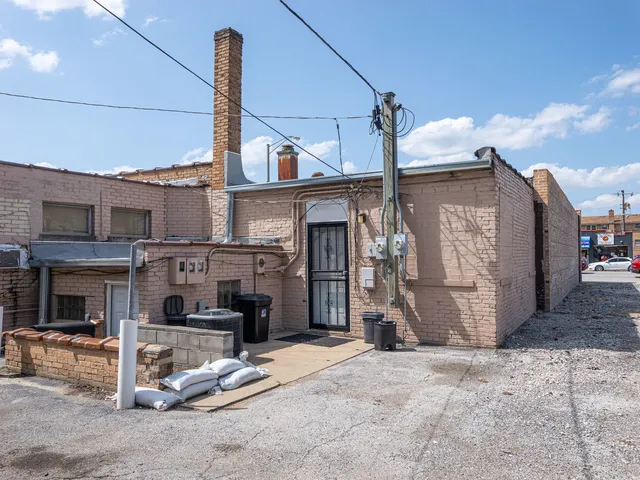 a view of a house with a patio and a yard
