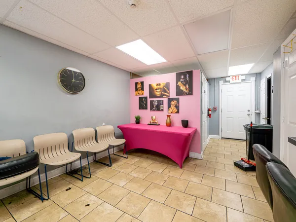 a bedroom with furniture and a window