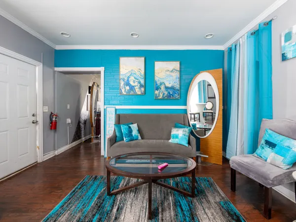 a view of a room with furniture and wooden floor