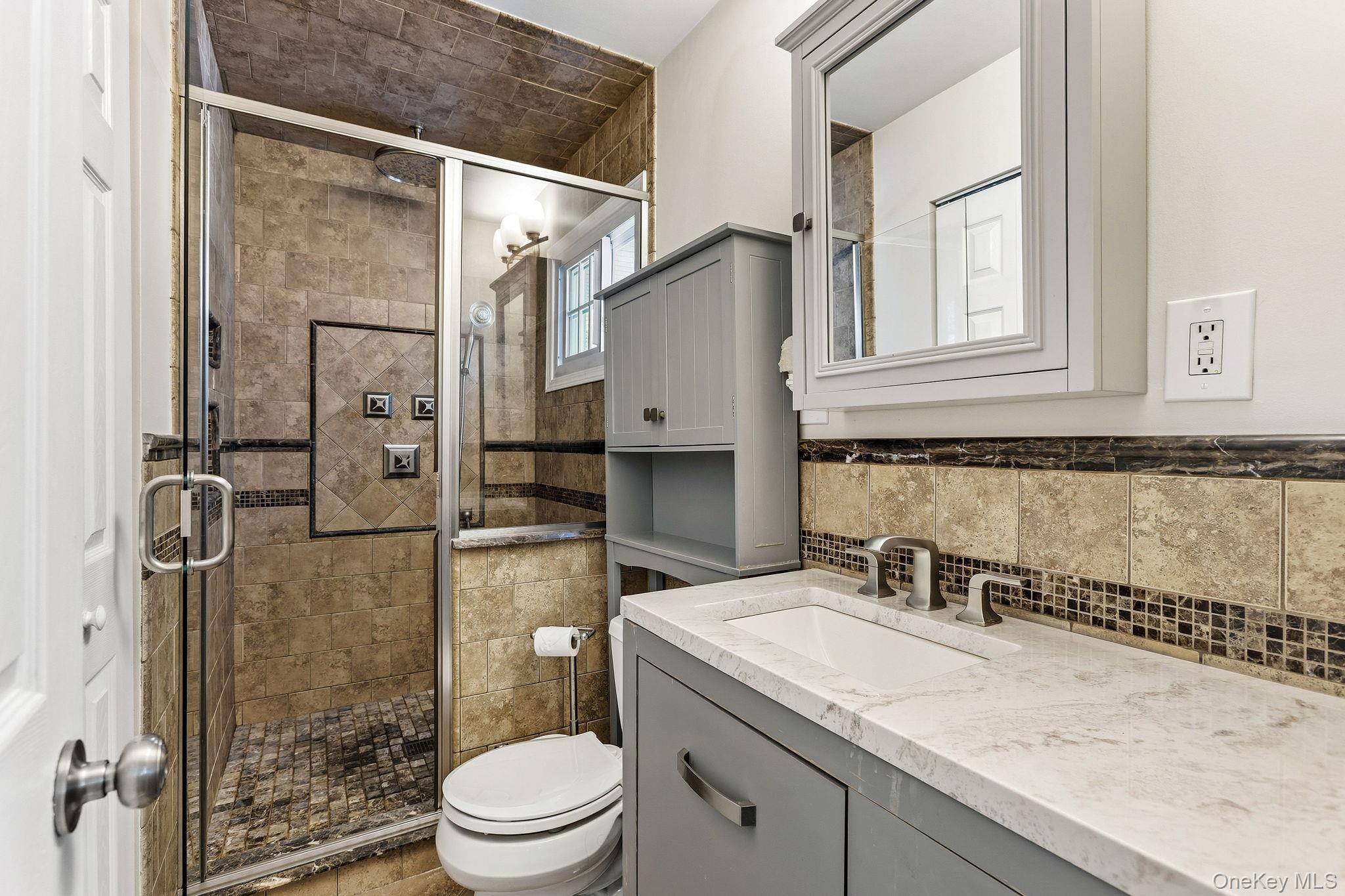56 Tanager Road Mahopac, NY 10541 - Photo 15 of 30 a bathroom with a granite countertop sink toilet and shower