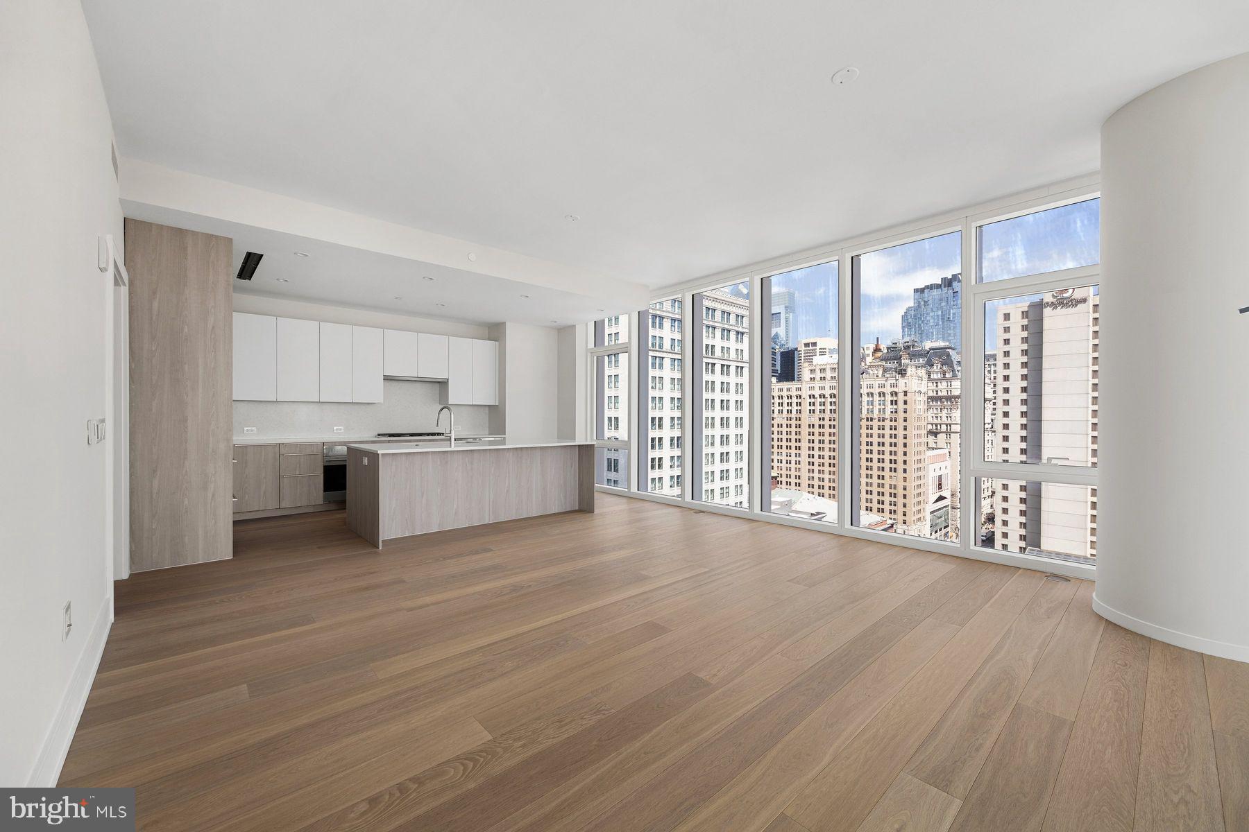 a view of a kitchen with wooden floor and a kitchen