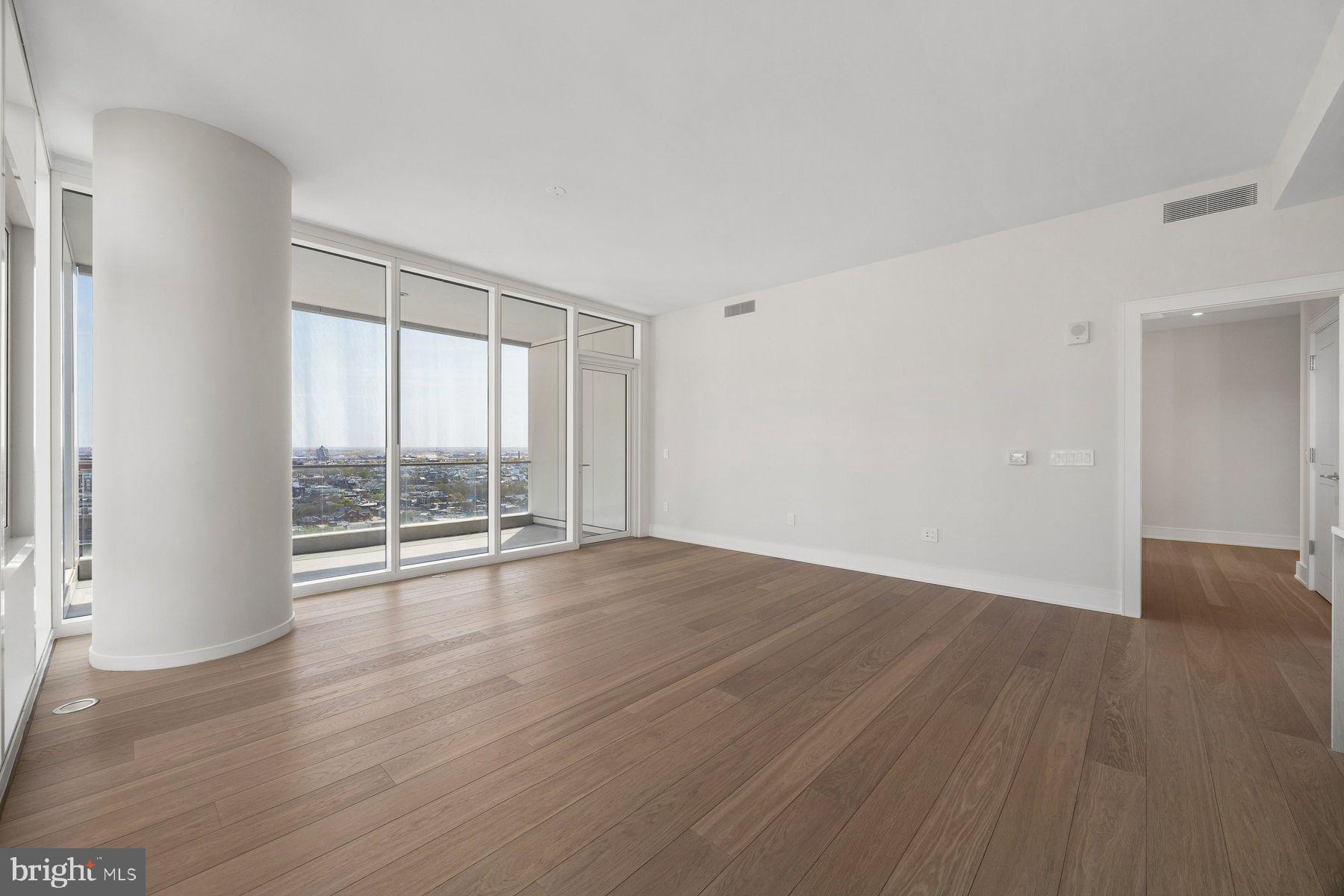 301 South Broad Street, Unit 1902 Philadelphia, PA 19107 - Photo 16 of 44 a view of an empty room with wooden floor and a window