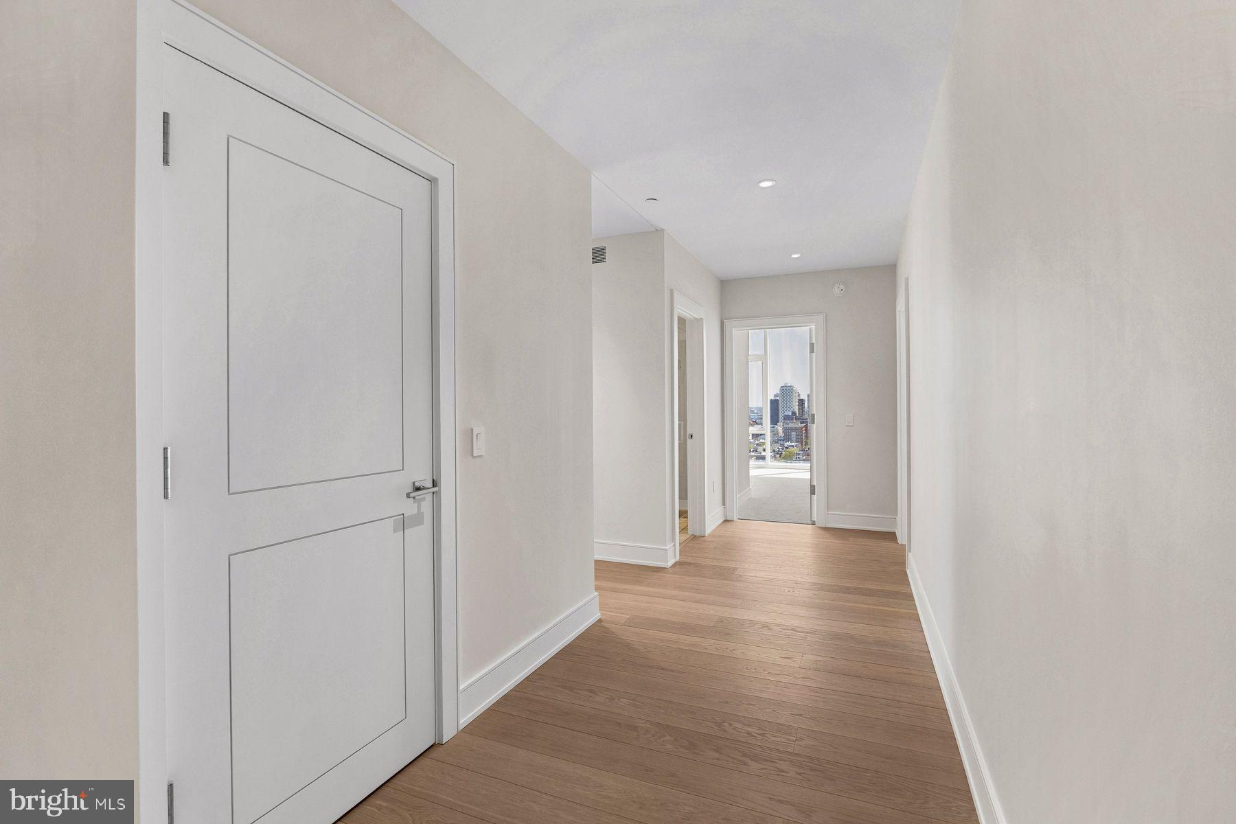 301 South Broad Street, Unit 1902 Philadelphia, PA 19107 - Photo 17 of 44 a view of a hallway with wooden floor