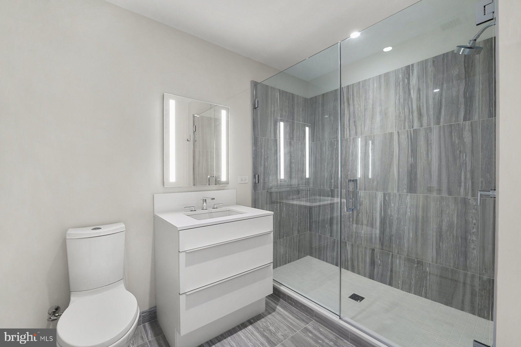 301 South Broad Street, Unit 1902 Philadelphia, PA 19107 - Photo 28 of 44 a bathroom with a sink a toilet and shower