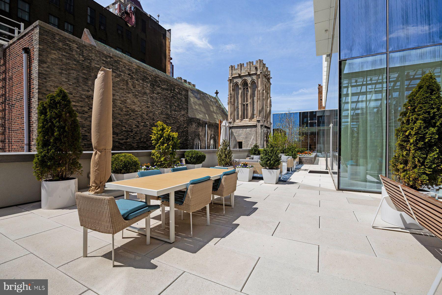 301 South Broad Street, Unit 1902 Philadelphia, PA 19107 - Photo 35 of 44 a view of a patio with a table and chairs and potted plants