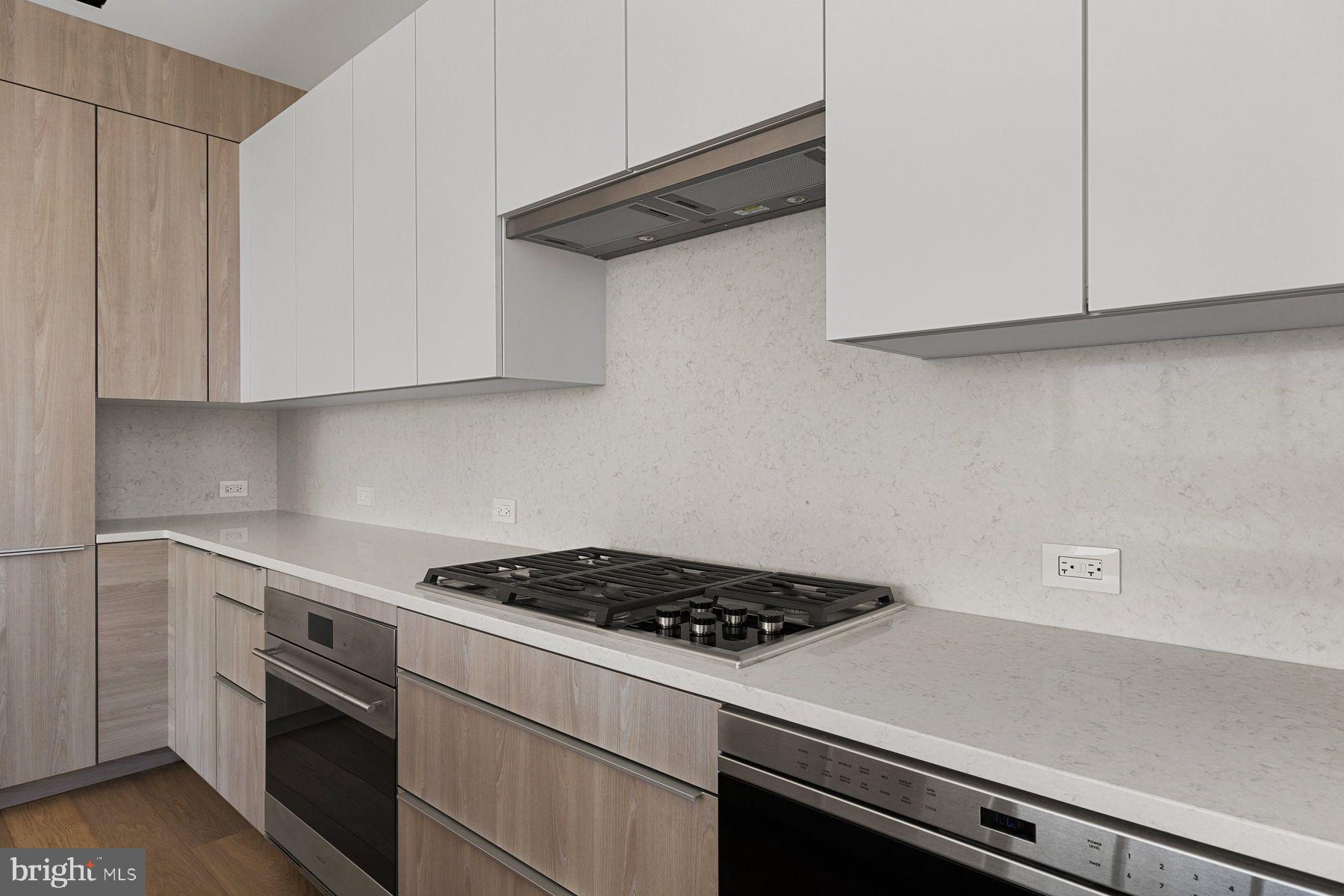 301 South Broad Street, Unit 1902 Philadelphia, PA 19107 - Photo 9 of 44 a kitchen with stainless steel appliances white cabinets and a stove
