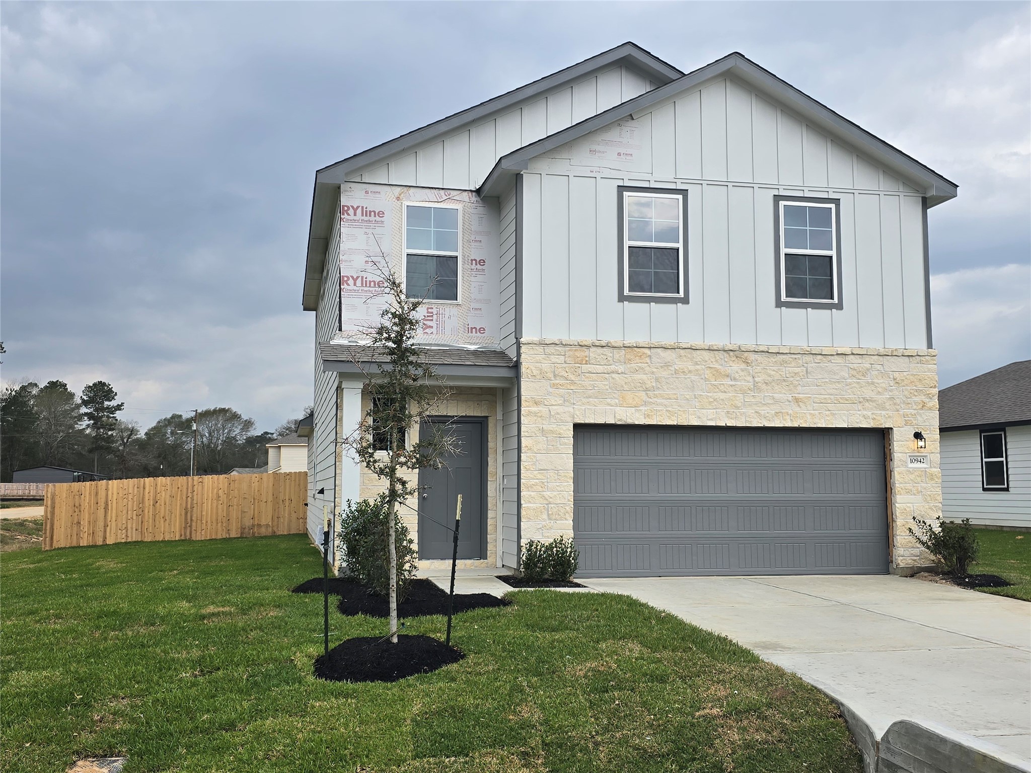 a front view of a house with a yard and garage