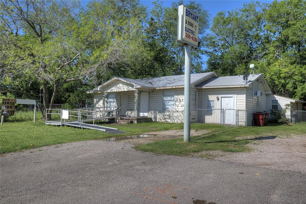 8782 Highway 34 Quinlan, TX 75474 - Photo 16 of 37 a front view of a house with a yard and trees
